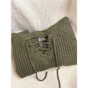 Olive green knit sweater with cutout neck.